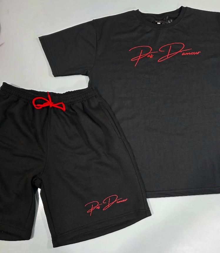 Black t-shirt and shorts set with red branding on a light gray background