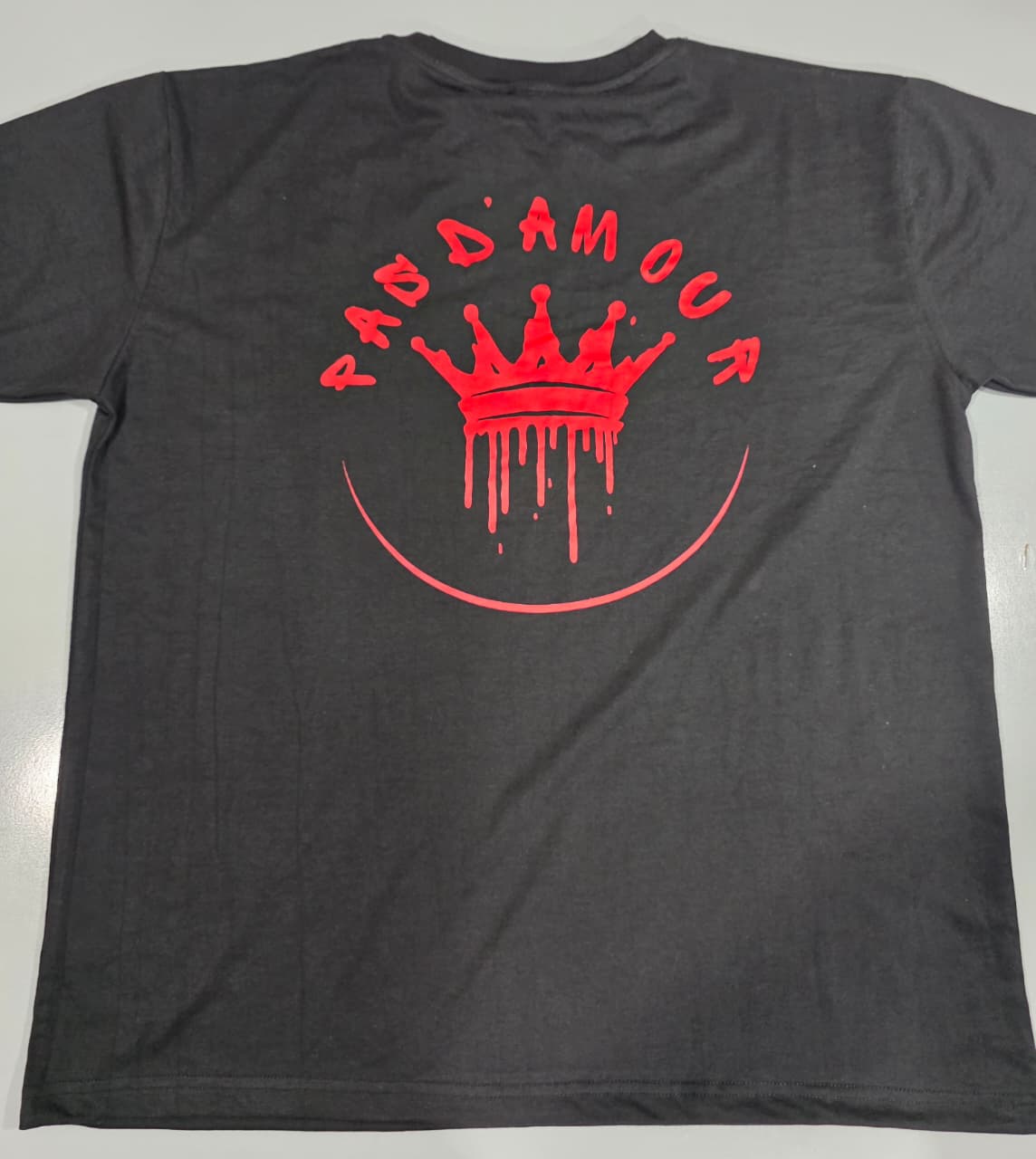Gray t-shirt with red graphic design on a white background